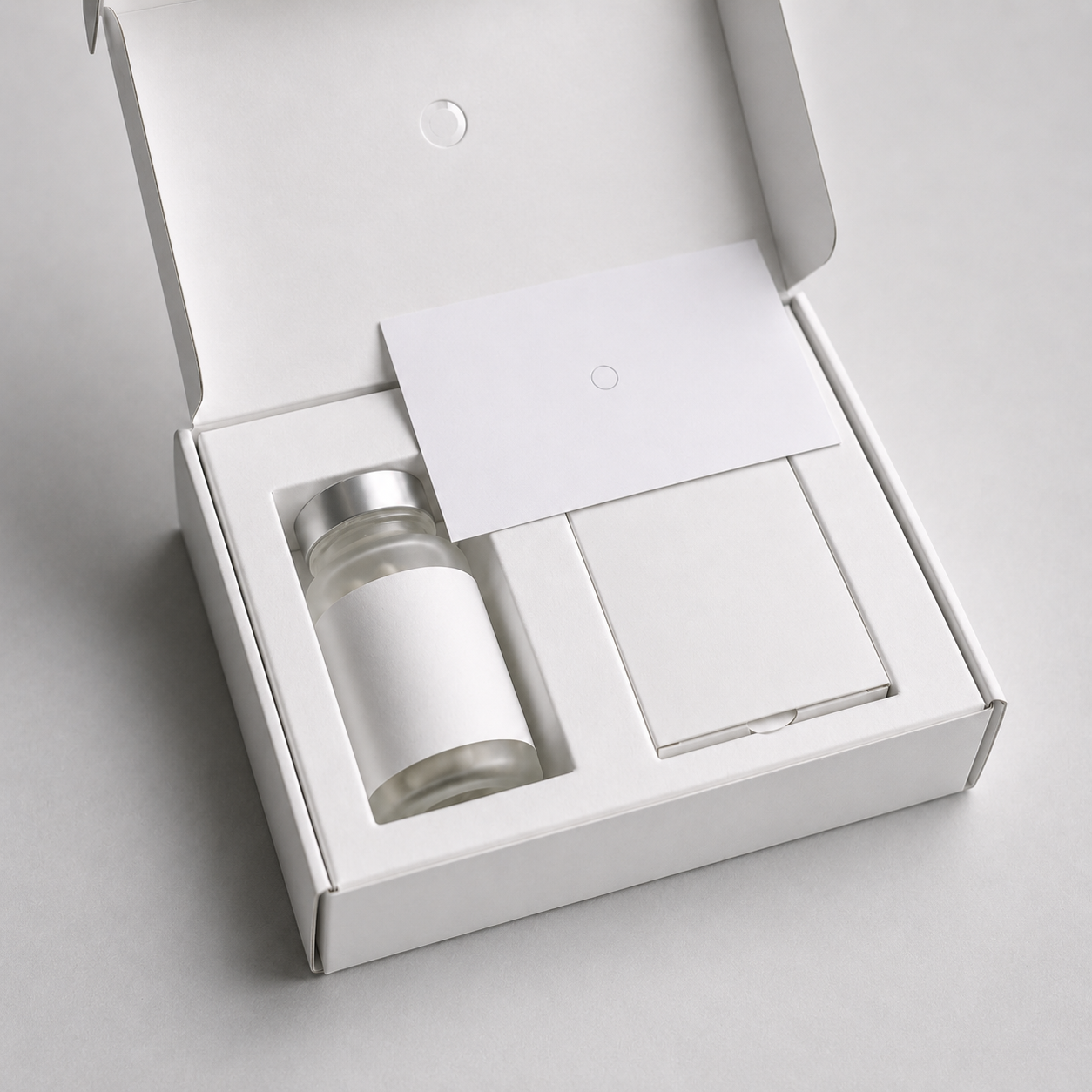 The Libra monthly box, open, with the bottle and test kit in a fitted nest